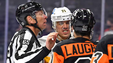May 3, 2021; Philadelphia, Pennsylvania, USA; Pittsburgh Penguins center Evgeni Malkin (71) and Philadelphia Flyers left wing Scott Laughton (21) are separated by linesman Pierre Racicot (65) during the second period at Wells Fargo Center. Mandatory Credit: Eric Hartline-USA TODAY Sports