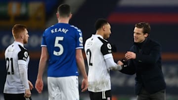 Fulham's English manager Scott Parker (R) congratulates Fulham's Dutch defender Kenny Tete (2nd R) at the end of the game during the English Premier League football match between Everton and Fulham at Goodison Park in Liverpool, north west England on February 14, 2021. - Fulham won the game 2-0. (Photo by Michael Regan / POOL / AFP) / RESTRICTED TO EDITORIAL USE. No use with unauthorized audio, video, data, fixture lists, club/league logos or 'live' services. Online in-match use limited to 120 images. An additional 40 images may be used in extra time. No video emulation. Social media in-match use limited to 120 images. An additional 40 images may be used in extra time. No use in betting publications, games or single club/league/player publications. / (Photo by MICHAEL REGAN/POOL/AFP via Getty Images)
