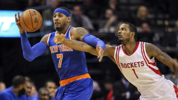 Nov 21, 2015; Houston, TX, USA; New York Knicks forward Carmelo Anthony (7) attempts to control the ball as Houston Rockets forward Trevor Ariza (1) defends during the first quarter at Toyota Center. Mandatory Credit: Troy Taormina-USA TODAY Sports