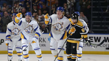 BUFFALO, NEW YORK - NOVEMBER 02: Kyle Okposo (L) and Rasmus Dahlin #26 of the Buffalo Sabres celebrate after an empty-net goal by Okposo during the third period against the Pittsburgh Penguins at KeyBank Center on November 02, 2022 in Buffalo, New York. (Photo by Joshua Bessex/Getty Images)