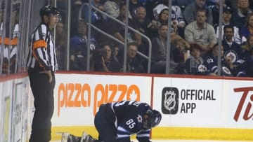 Sep 29, 2016; Winnipeg, Manitoba, CAN; Winnipeg Jets forward Mathieu Perreault (85) is injured during the third period during a preseason hockey game against the Minnesota Wild at MTS Centre. Winnipeg wins 4-1. Mandatory Credit: Bruce Fedyck-USA TODAY Sports