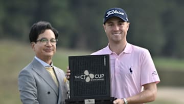 Justin Thomas of the US (R) and Lee Jay-hyun (L), chairman of the South Korean food and entertainment giant CJ Group, pose with the trophy after winning the CJ Cup golf tournament at Nine Bridges golf club in Jeju Island on October 20, 2019. (Photo by Jung Yeon-je / AFP) (Photo by JUNG YEON-JE/AFP via Getty Images)