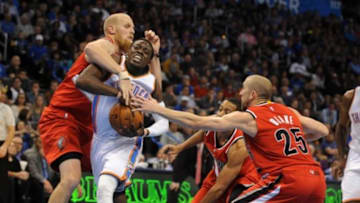 Dec 23, 2014; Oklahoma City, OK, USA; Oklahoma City Thunder guard Reggie Jackson (15) drives to the basket against Portland Trail Blazers center Chris Kaman (35) and guard Steve Blake (25) during the fourth quarter at Chesapeake Energy Arena. Mandatory Credit: Mark D. Smith-USA TODAY Sports