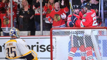 Apr 7, 2013; Chicago, IL, USA; Chicago Blackhawks left wing Bryan Bickell (middle) is congratulated by left wing Viktor Stalberg (left) and center Michal Handzus (right) for scoring a goal against Nashville Predators goalie Pekka Rinne (35) during the second period at the United Center. Mandatory Credit: Rob Grabowski-USA TODAY Sports