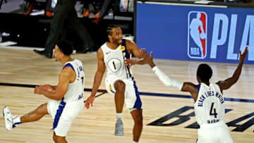 Aug 8, 2020; Lake Buena Vista, Florida, USA; Indiana Pacers forward T.J. Warren (1) celebrates with guard Malcolm Brogdon (7) and guard Victor Oladipo (4) after a play against the Los Angeles Lakers in a NBA basketball game at The Field House. Mandatory Credit: Kim Klement-USA TODAY Sports