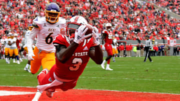 RALEIGH, NC - DECEMBER 01: Kelvin Harmon #3 of the North Carolina State Wolfpack catches a pass for a 14-yard touchdown against Marcus Holton Jr. #6 of the East Carolina Pirates in the first quarter at Carter-Finley Stadium on December 1, 2018 in Raleigh, North Carolina. (Photo by Lance King/Getty Images)