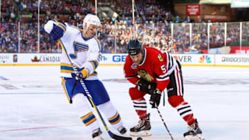 ST. LOUIS, MO - DECEMBER 31: Barrett Jackman #5 of the St. Louis Blues Alumni Team and Ben Eager #55 of the Chicago Blackhawks Alumni Team chase the puck during the Alumni Game as part of the 2017 Bridgestone NHL Winter Classic at Busch Stadium on December 31, 2016 in St Louis, Missouri. (Photo by Chase Agnello-Dean/NHLI via Getty Images)