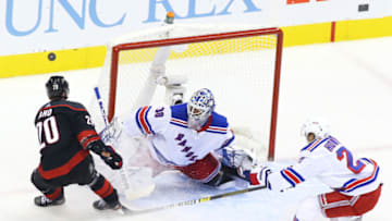 TORONTO, ONTARIO - AUGUST 03: Henrik Lundqvist #30 of the New York Rangers saves a shot from Sebastian Aho #20 of the Carolina Hurricanes in Game Two of the Eastern Conference Qualification Round prior to the 2020 NHL Stanley Cup Playoffs at Scotiabank Arena on August 3, 2020 in Toronto, Ontario, Canada. (Photo by Andre Ringuette/Freestyle Photo/Getty Images)