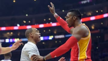May 10, 2015; Los Angeles, CA, USA; Houston Rockets center Dwight Howard (12) is restrained by referee Danny Crawford (48) in the first quarter against the Los Angeles Clippers in game three of the second round of the NBA Playoffs. at Staples Center. Mandatory Credit: Kirby Lee-USA TODAY Sports