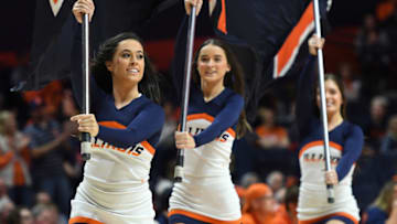CHAMPAIGN, IL - DECEMBER 29: Illinois Fighting Illini cheerleaders run across the court carrying flags during the college basketball game between the Florida Atlantic University Owls and the Illinois Fighting Illini on December 29, 2018, at the State Farm Center in Champaign, Illinois. (Photo by Michael Allio/Icon Sportswire via Getty Images)