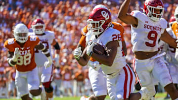 Oct 9, 2021; Dallas, Texas, USA; Oklahoma Sooners running back Kennedy Brooks (26) runs for a touchdown during the fourth quarter against the Texas Longhorns at the Cotton Bowl. Mandatory Credit: Kevin Jairaj-USA TODAY Sports