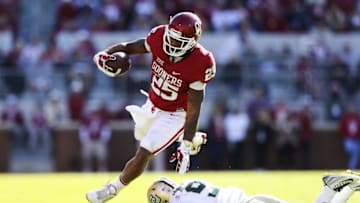 Nov 12, 2016; Norman, OK, USA; Oklahoma Sooners running back Joe Mixon (25) jumps over Baylor Bears cornerback Ryan Reid (9) during the second half at Gaylord Family - Oklahoma Memorial Stadium. Mandatory Credit: Kevin Jairaj-USA TODAY Sports