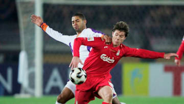 YOKOHAMA, JAPAN - DECEMBER 15: Xabi Alonso of Liverpool is challenged by Alvaro Saborio of Deportivo Saprissa during the FIFA Club World Championship Toyota Cup 2005 match between Deportivo Saprissa and Liverpool at The Yokohama International Stadium on December 15, 2005 in Yokohama, Japan. (Photo by Shaun Botterill/Getty Images)