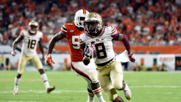 Oct 8, 2016; Miami Gardens, FL, USA; Florida State Seminoles wide receiver Kermit Whitfield (8) carries the ball past Miami Hurricanes linebacker Michael Pinckney (56) during the second half at Hard Rock Stadium. FSU won 20-19. Mandatory Credit: Steve Mitchell-USA TODAY Sports