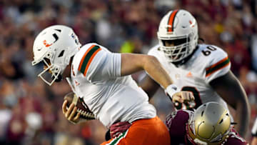 Nov 13, 2021; Tallahassee, Florida, USA; Miami Hurricanes quarterback Tyler Van Dyke (9) is tackled by Florida State Seminoles defensive end Jermaine Johnson II (11) during the game at Doak S. Campbell Stadium. Mandatory Credit: Melina Myers-USA TODAY Sports