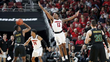 LOUISVILLE, KY - NOVEMBER 16: V.J. King #13 of the Louisville Cardinals defends against Stef Smith #0 of the Vermont Catamounts in the first half of the game at KFC YUM! Center on November 16, 2018 in Louisville, Kentucky. Louisville won 86-78. (Photo by Joe Robbins/Getty Images)