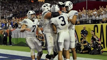 Sep 3, 2016; Glendale, AZ, USA; Brigham Young Cougars quarterback Taysom Hill (7) offensive lineman Parker Dawe (54) wide receiver Colby Pearson (3) and wide receiver Nick Kurtz (5) celebrate after scoring a touchdown against the Arizona Wildcats during the fourth quarter at University of Phoenix Stadium. The Cougars won 18-16. Mandatory Credit: Casey Sapio-USA TODAY Sports