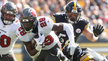 Oct 16, 2022; Pittsburgh, Pennsylvania, USA; Tampa Bay Buccaneers running back Rachaad White (29) runs the ball against Pittsburgh Steelers defensive tackle Chris Wormley (bottom) and linebacker Alex Highsmith (56) during the first quarter at Acrisure Stadium. Mandatory Credit: Charles LeClaire-USA TODAY Sports