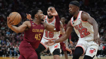 Cleveland Cavaliers guard Donovan Mitchell (45) drives to the basket as Miami Heat forward Jimmy Butler (22) and forward Caleb Martin (16) defend(Jim Rassol-USA TODAY Sports)