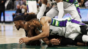 Milwaukee Bucks forward Giannis Antetokounmpo (34) and Miami Heat forward Jimmy Butler (22) battle for control of the ball during the fourth quarter(Jeff Hanisch-USA TODAY Sports)