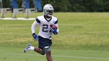 May 25, 2016; Irving, TX, USA; Dallas Cowboys running back Ezekiel Elliott (21) runs with the ball during organized team activities at Dallas Cowboys Headquarters. Mandatory Credit: Matthew Emmons-USA TODAY Sports