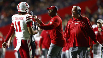 Quarterback Casey Thompson #11 of the Nebraska Cornhuskers talks with head coach Mickey Joseph and offensive coordinator Mark Whipple(Photo by Rich Schultz/Getty Images)