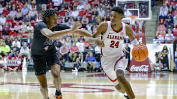 TUSCALOOSA, AL - DECEMBER 13: Brandon Miller #24 of the Alabama Crimson Tide works to the basket around Chandler Lawson #4 of the Memphis Tigers during the first half at Coleman Coliseum on December 13, 2022 in Tuscaloosa, Alabama. (Photo by Brandon Sumrall/Getty Images)