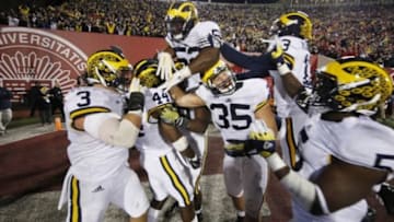 Nov 14, 2015; Bloomington, IN, USA; Michigan Wolverines safety Delano Hill (44) celebrates with teammates after making the last defensive play of the game to give Michigan the victory against the Indiana Hoosiers at Memorial Stadium. Michigan defeats Indiana in double overtime 48-41. Mandatory Credit: Brian Spurlock-USA TODAY Sports