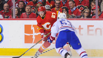 CALGARY, AB - NOVEMBER 15: Austin Czarnik #27 of the Calgary Flames carries the puck against Victor Mete #53 of the Montreal Canadiens during an NHL game at Scotiabank Saddledome on November 15, 2018 in Calgary, Alberta, Canada. (Photo by Derek Leung/Getty Images)