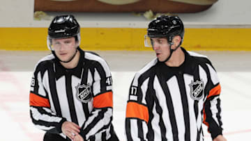 NEWARK, NEW JERSEY - MAY 04: Referee Mark Lemelin #41 and referee Frederick L'Ecuyer #17 work the game between the New Jersey Devils and the Boston Bruins at the Prudential Center on May 04, 2021 in Newark, New Jersey. (Photo by Bruce Bennett/Getty Images)