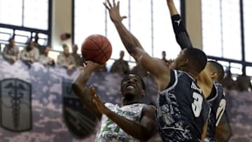 Nov 8, 2013; Seoul, SOUTH KOREA; Oregon Ducks player Damyean Dotson (left) shoots against Georgetown Hoyas players Mikael Hopkins (middle) and Stephen Domingo during a NCAA basketball game at Camp Humphreys. Mandatory Credit: Kim Hong-Ji/Reuters via USA TODA Sports