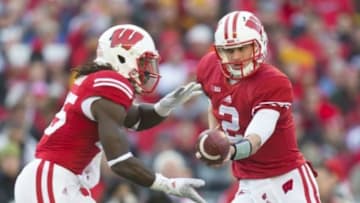 Nov 29, 2014; Madison, WI, USA; Wisconsin Badgers quarterback Joel Stave (2) hands the football off to running back Melvin Gordon (25) during the first quarter against the Minnesota Golden Gophers at Camp Randall Stadium. Mandatory Credit: Jeff Hanisch-USA TODAY Sports
