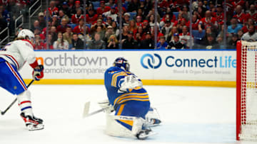 BUFFALO, NY - MARCH 27: Michael Pezzetta #55 of the Montreal Canadiens scores the winning goal against Eric Comrie #31 of the Buffalo Sabres during the shootout at KeyBank Center on March 27, 2023 in Buffalo, New York. (Photo by Kevin Hoffman/Getty Images)