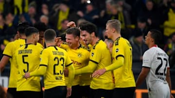 Dortmund's Polish defender Lukasz Piszczek (C) celebrates scoring the opening goal with his teammates during the German first division Bundesliga football match BVB Borussia Dortmund vs Eintracht Frankfurt, in Dortmund, western Germany on February 14, 2020. (Photo by INA FASSBENDER / AFP) / RESTRICTIONS: DFL REGULATIONS PROHIBIT ANY USE OF PHOTOGRAPHS AS IMAGE SEQUENCES AND/OR QUASI-VIDEO (Photo by INA FASSBENDER/AFP via Getty Images)