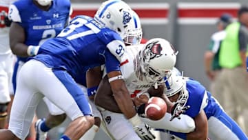 RALEIGH, NC - SEPTEMBER 08: Victor Heyward #37 and Chris Bacon #3 of the Georgia State Panthers force a fumble by Stephen Louis #1 of the North Carolina State Wolfpack during their game at Carter-Finley Stadium on September 8, 2018 in Raleigh, North Carolina. North Carolina Sate won 41-7. (Photo by Grant Halverson/Getty Images)