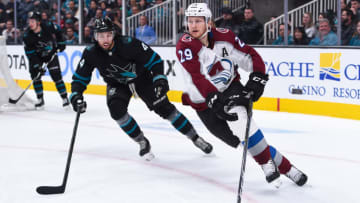 SAN JOSE, CA - MARCH 01: Colorado Avalanche Center Nathan MacKinnon (29) controls the puck as he skates past San Jose Sharks Defenceman Brenden Dillon (4) during the NHL game between the Colorado Avalanche and the San Jose Sharks at SAP Center on March 1, 2019 in San Jose, CA. (Photo by Cody Glenn/Icon Sportswire via Getty Images)
