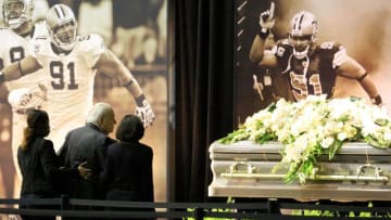Apr 15, 2016; Metairie, LA, USA; New Orleans Saints owners Tom Benson and wife Gayle Benson walk up to the casket during visitation hosted by the New Orleans Saints and the family of Will Smith for former NFL teammates, fans and guests wishing to pay their final respects to Will Smith at the Saints indoor practice facility. Mandatory Credit: Derick E. Hingle-USA TODAY Sports