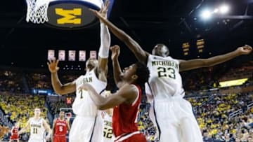 Mar 8, 2014; Ann Arbor, MI, USA; Michigan Wolverines forward Glenn Robinson III (1) guard Caris LeVert (23) and Indiana Hoosiers guard Stanford Robinson (22) go for the rebound at Crisler Arena. Mandatory Credit: Rick Osentoski-USA TODAY Sports