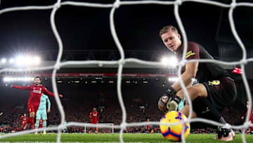 LIVERPOOL, ENGLAND - DECEMBER 29: Bernd Leno of Arsenal shows hos dejection as Mohamed Salah of Liverpool celebrates after his team mate Roberto Firmino has scored the first goal during the Premier League match between Liverpool FC and Arsenal FC at Anfield on December 29, 2018 in Liverpool, United Kingdom. (Photo by Clive Brunskill/Getty Images)