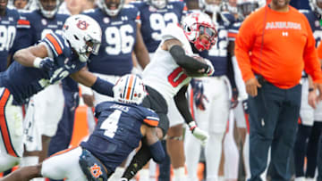 Auburn footballAUBURN, ALABAMA - NOVEMBER 19: Wide receiver Jaylen Hall #0 of the Western Kentucky Hilltoppers looks to escape a tackle by cornerback D.J. James #4 of the Auburn Tigers at Jordan-Hare Stadium on November 19, 2022 in Auburn, Alabama. (Photo by Michael Chang/Getty Images)