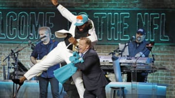 NASHVILLE, TENNESSEE - APRIL 25: Christian Wilkins jump into NFL Commissioner Roger Goodell after he is drafted thirteenth overall by the Miami Dolphins on day 1 of the 2019 NFL Draft on April 25, 2019 in Nashville, Tennessee. (Photo by Frederick Breedon/Getty Images)