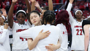 U of L's Norika Konno (11) embraces a teammate after their 68-65 loss to Notre Dame on Senior Day at the Yum Center in Louisville, Ky. on Feb. 26, 2023.Uofl Dame04 Sam
