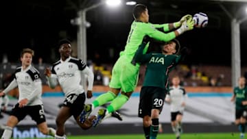 Fulham's French goalkeeper Alphonse Areola (CL) makes a save above Tottenham Hotspur's English midfielder Dele Alli during the English Premier League football match between Fulham and Tottenham Hotspur at Craven Cottage in London on March 4, 2021. (Photo by KIRSTY WIGGLESWORTH/POOL/AFP via Getty Images)