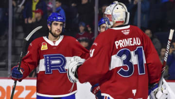 LAVAL, QC - DECEMBER 28: Josh Brook and Cayden Primeau (Photo by Minas Panagiotakis/Getty Images)