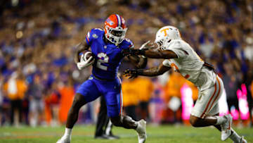 GAINESVILLE, FLORIDA - SEPTEMBER 16: Montrell Johnson Jr. #2 of the Florida Gators runs the ball against Tamarion McDonald #12 of the Tennessee Volunteers during the first half of a game at Ben Hill Griffin Stadium on September 16, 2023 in Gainesville, Florida. (Photo by James Gilbert/Getty Images)
