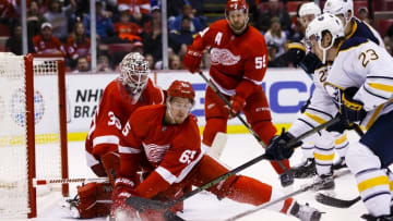 Mar 28, 2016; Detroit, MI, USA; Buffalo Sabres center Sam Reinhart (23) tries to score on Detroit Red Wings goalie Jimmy Howard (35) defended by defenseman Danny DeKeyser (65) in the third period at Joe Louis Arena. Detroit won 3-2. Mandatory Credit: Rick Osentoski-USA TODAY Sports