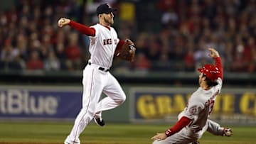 Oct 30, 2013; Boston, MA, USA; Boston Red Sox shortstop Stephen Drew (7) turns a double play over St. Louis Cardinals second baseman Matt Carpenter (13) during the third inning of game six of the MLB baseball World Series at Fenway Park. Mandatory Credit: Greg M. Cooper-USA TODAY Sports