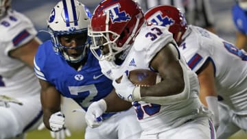 Oct 2, 2020; Provo, UT, USA; Louisiana Tech running back Justin Henderson (33) carries the ball as BYU defensive back George Udo (7) closes in for the tackle in the first half during an NCAA college football game Friday, Oct. 2, 2020, in Provo, Utah. Mandatory Credit: Rick Bowmer/Pool Photo-USA TODAY Sports
