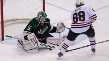 Apr 9, 2013; St. Paul, MN, USA; Minnesota Wild goalie Niklas Backstrom (32) makes a save on defends Chicago Blackhawks forward Patrick Kane (88) during the third period at the Xcel Energy Center. The Blackhawks defeated the Wild 1-0. Mandatory Credit: Brace Hemmelgarn-USA TODAY Sports
