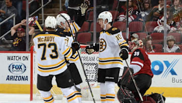 GLENDALE, AZ - OCTOBER 14: Anders Bjork #10, Charlie McAvoy #73 and Danton Heinen #43 of the Boston Bruins celebrate a third period goal against Louis Domingue #35 of the Arizona Coyotes at Gila River Arena on October 14, 2017 in Glendale, Arizona. Bruins won 6-2. (Photo by Norm Hall/NHLI via Getty Images)